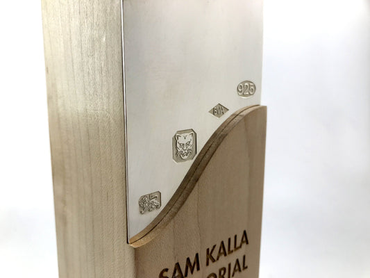 Beautiful engraved sterling silver award inlay on a white background