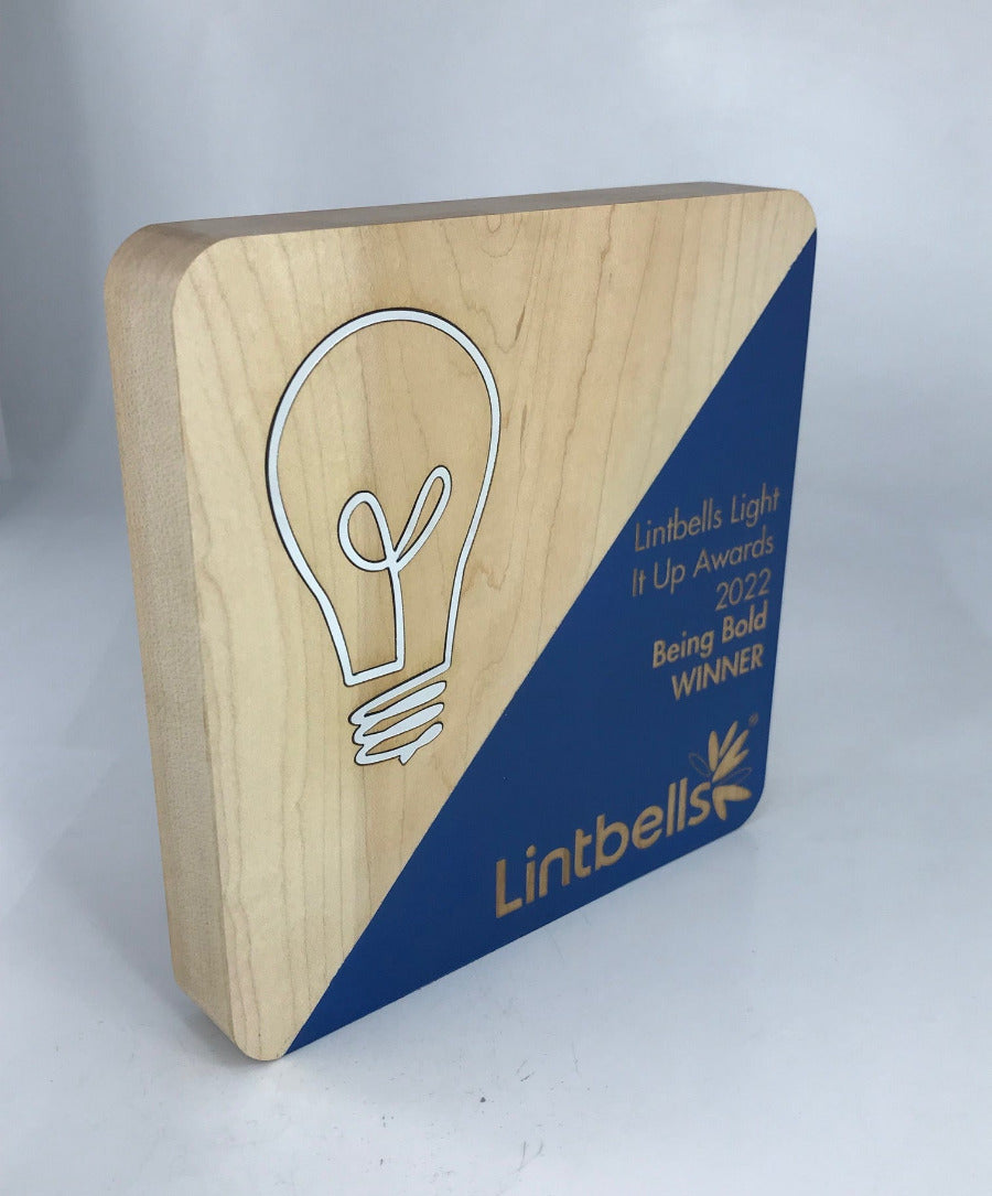 Wooden award with rounded corners, diagonal painted colour and engraved text