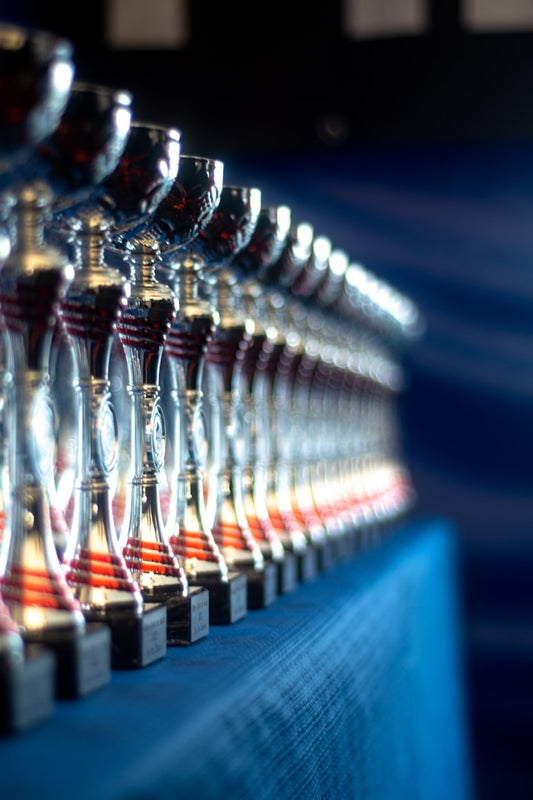 A line of awards on a blue cloth