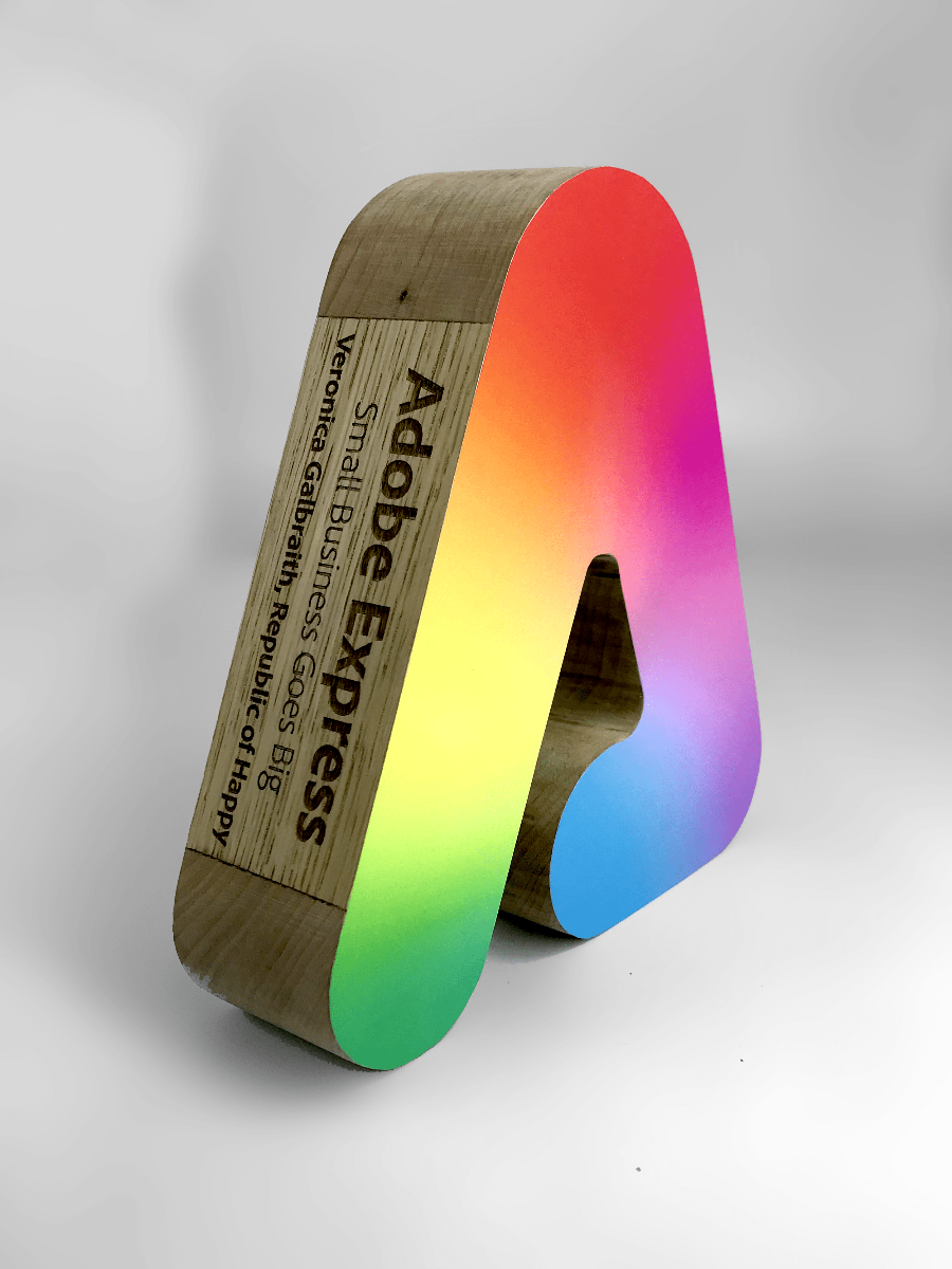 Wooden letter 'A' award with a rainbow gradient on a white background