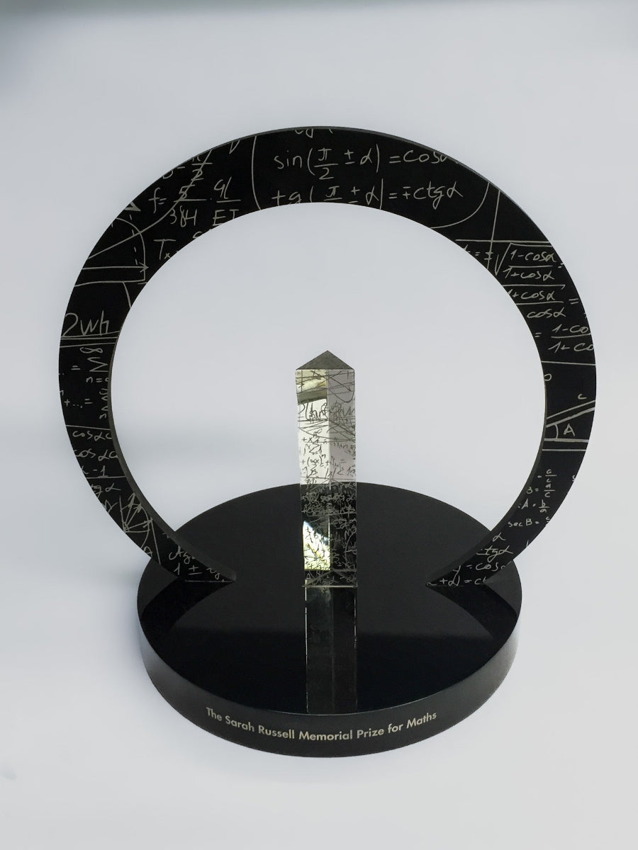 Decorative award with mathematical equations on a circular ring and black base