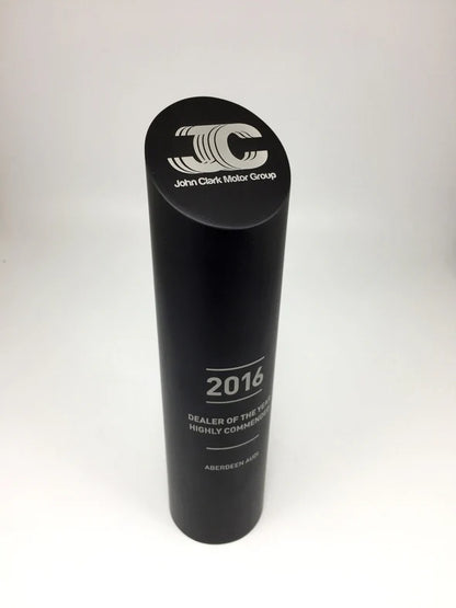Black cylindrical award with 'John Clark Motor Group' logo and text on a white background