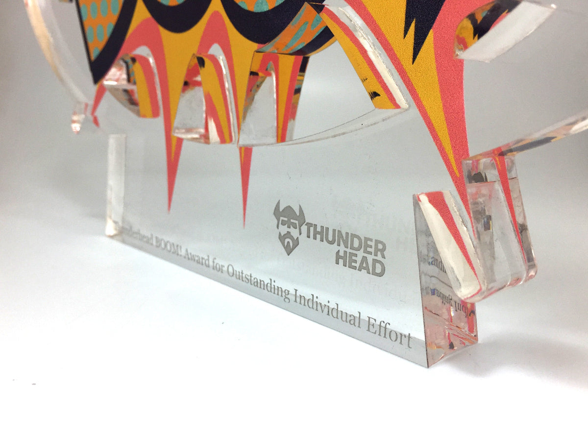 Decorative award with colorful design and 'Thunder Head' branding on a white background