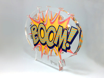 Decorative award with 'BOOM!' text on a clear stand against a white background
