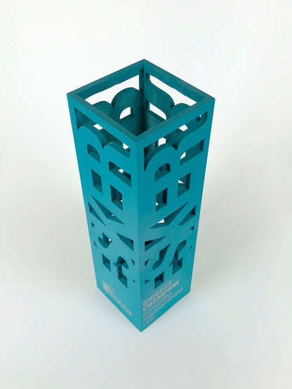 Teal metal "biggest champion" award with cut-out design on a white background