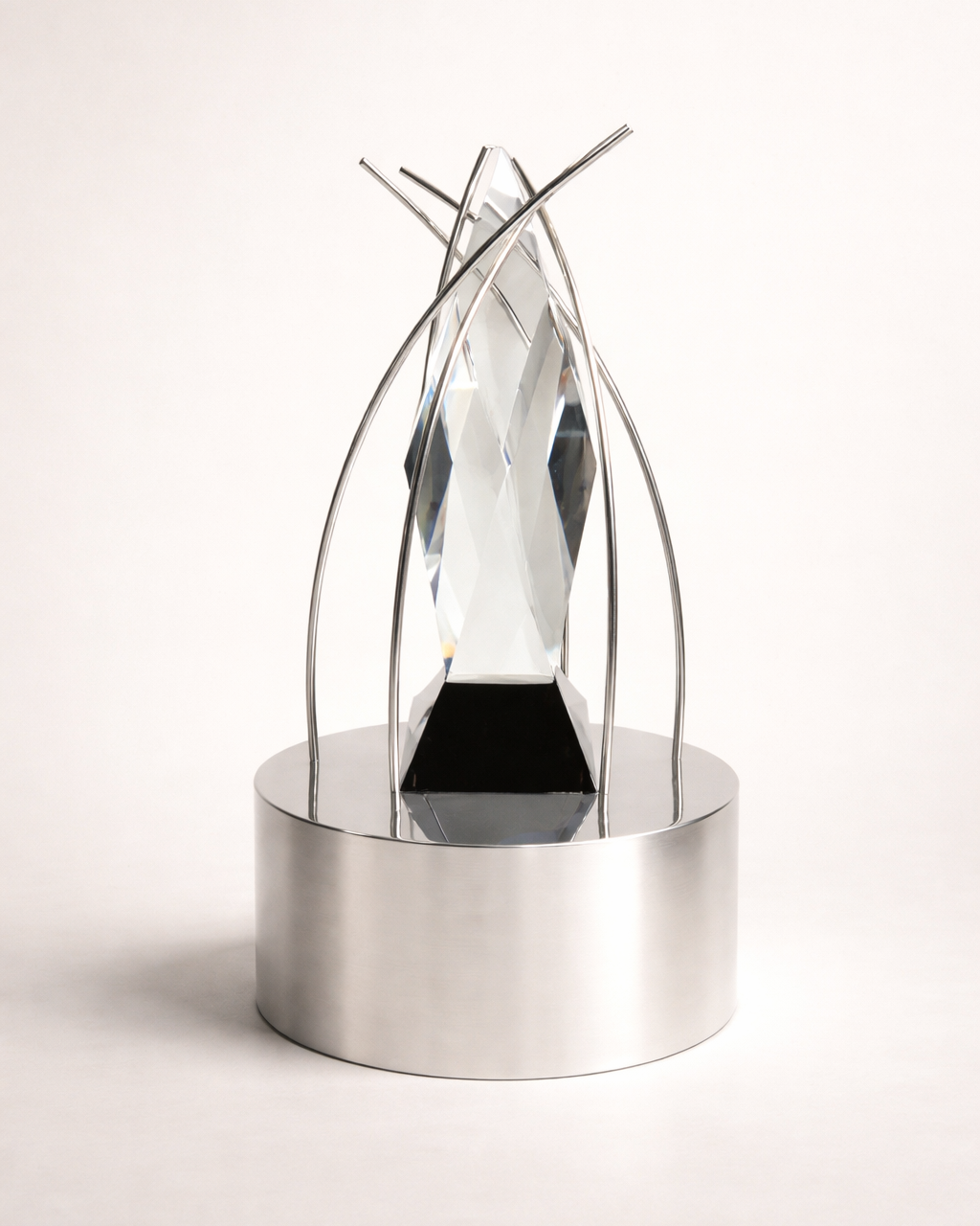 Modern decorative award with crystal class glass mounted on a metal base on a white background
