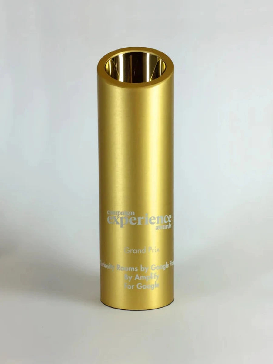 Gold cylindrical award with engraved text 