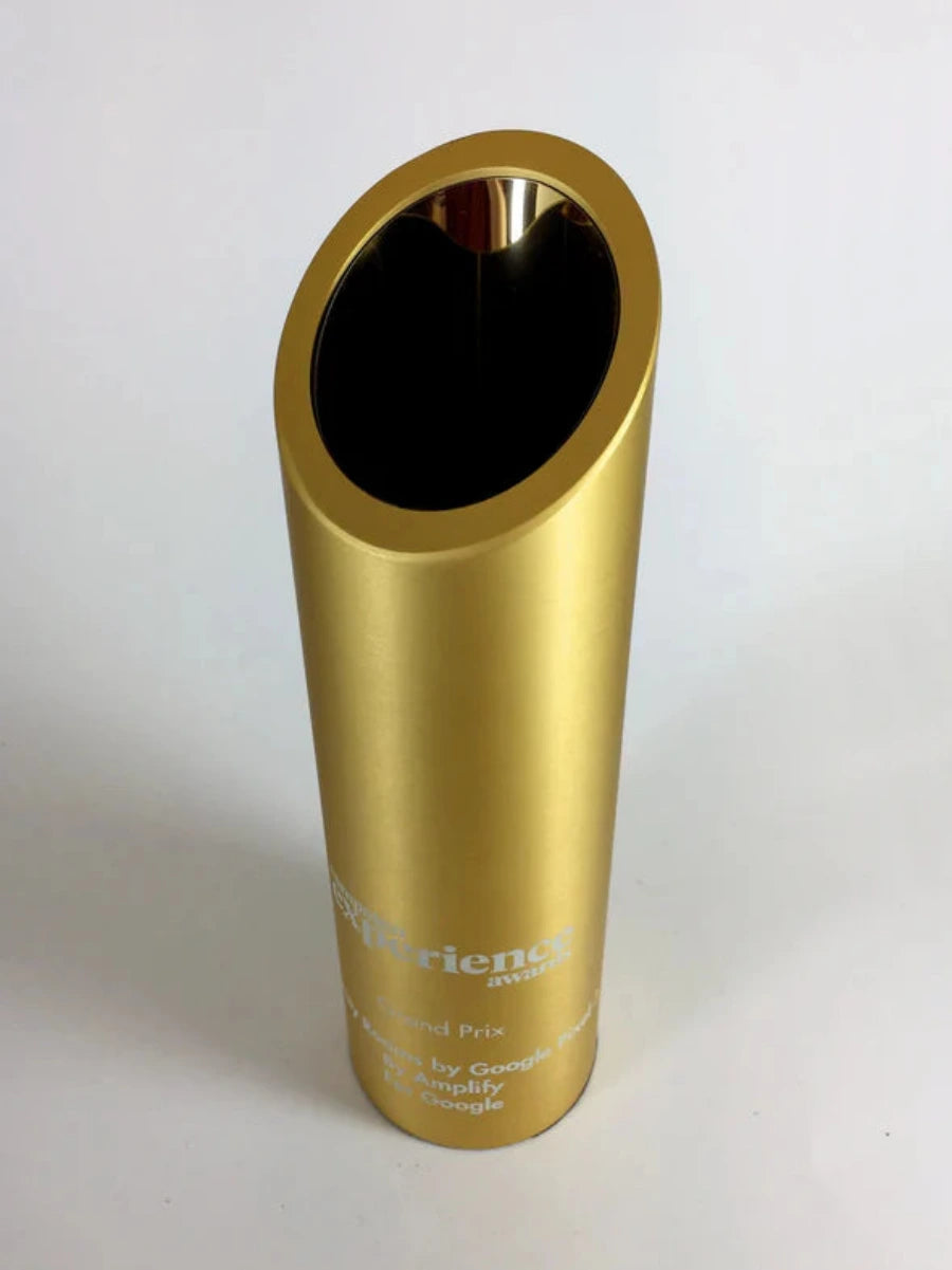 Gold cylindrical award with engraved text 