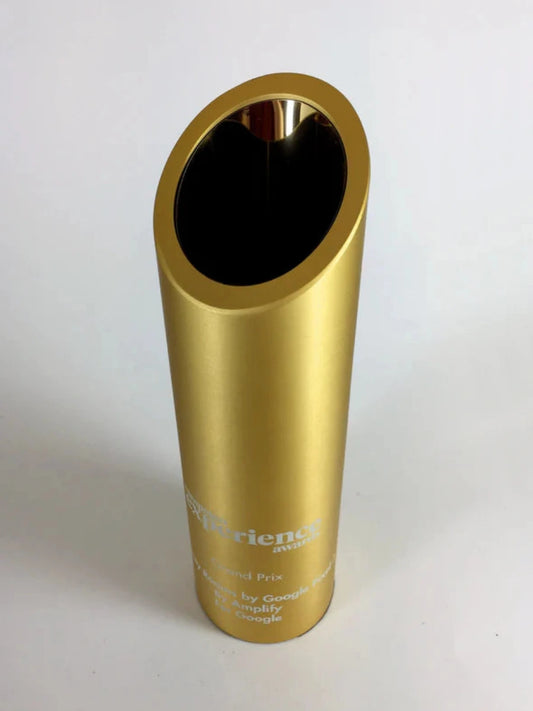 Gold cylindrical award with engraved text 