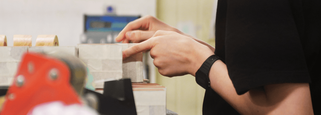 Hand-finishing bespoke wooden award blocks in our East London studio
