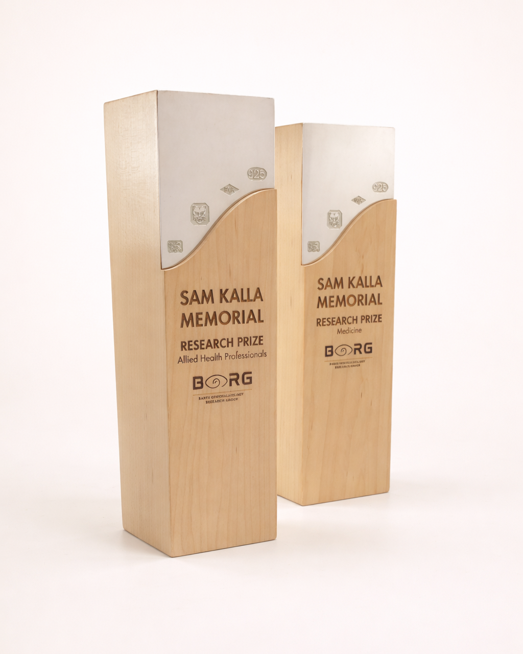 Two wooden awards with 'Sam Kalla Memorial Research Prize' branding on a white background