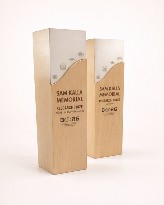 Two wooden awards with 'Sam Kalla Memorial Research Prize' branding on a white background