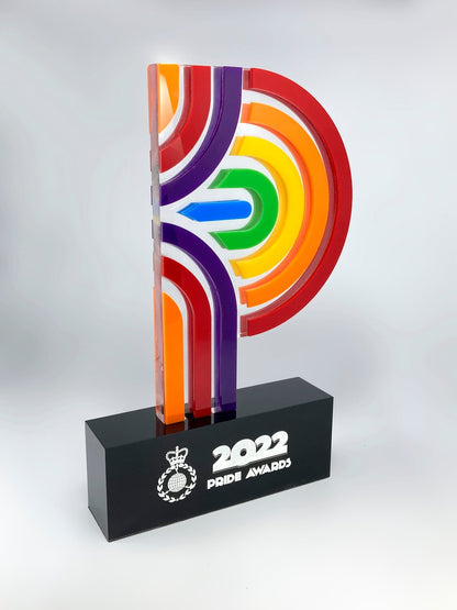  Bespoke layered acrylic pride trophy, angled view showing full rainbow colour spectrum and engraved black base