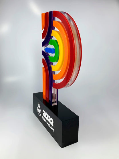 Side profile of colourful acrylic pride award showing layered clear and coloured acrylic construction