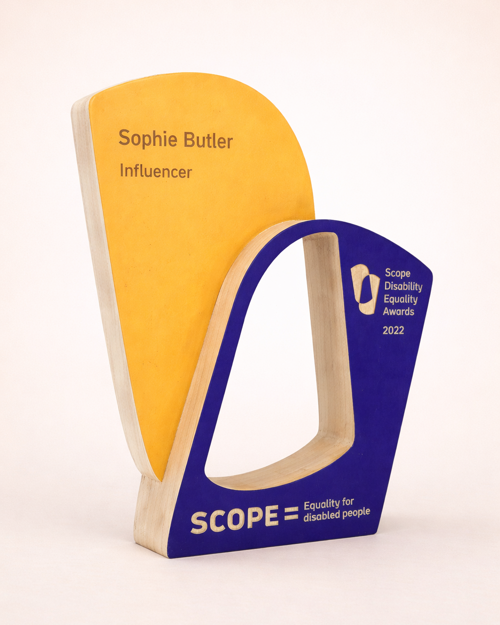 custom wooden cut out award for SCOPE  sprayed yellow and blue on a white background