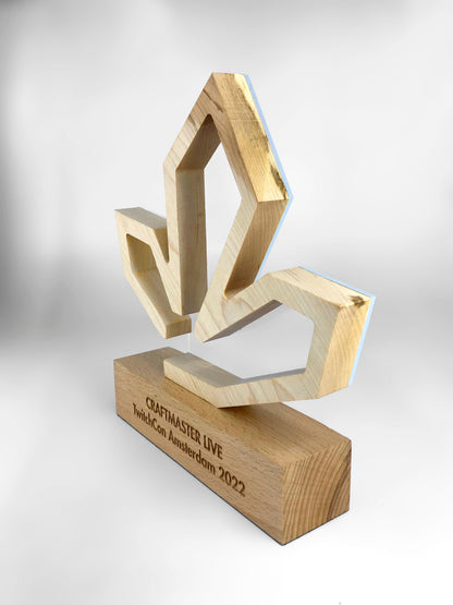 A maple graphic leaf cut out on a laser engraved wooden block award.