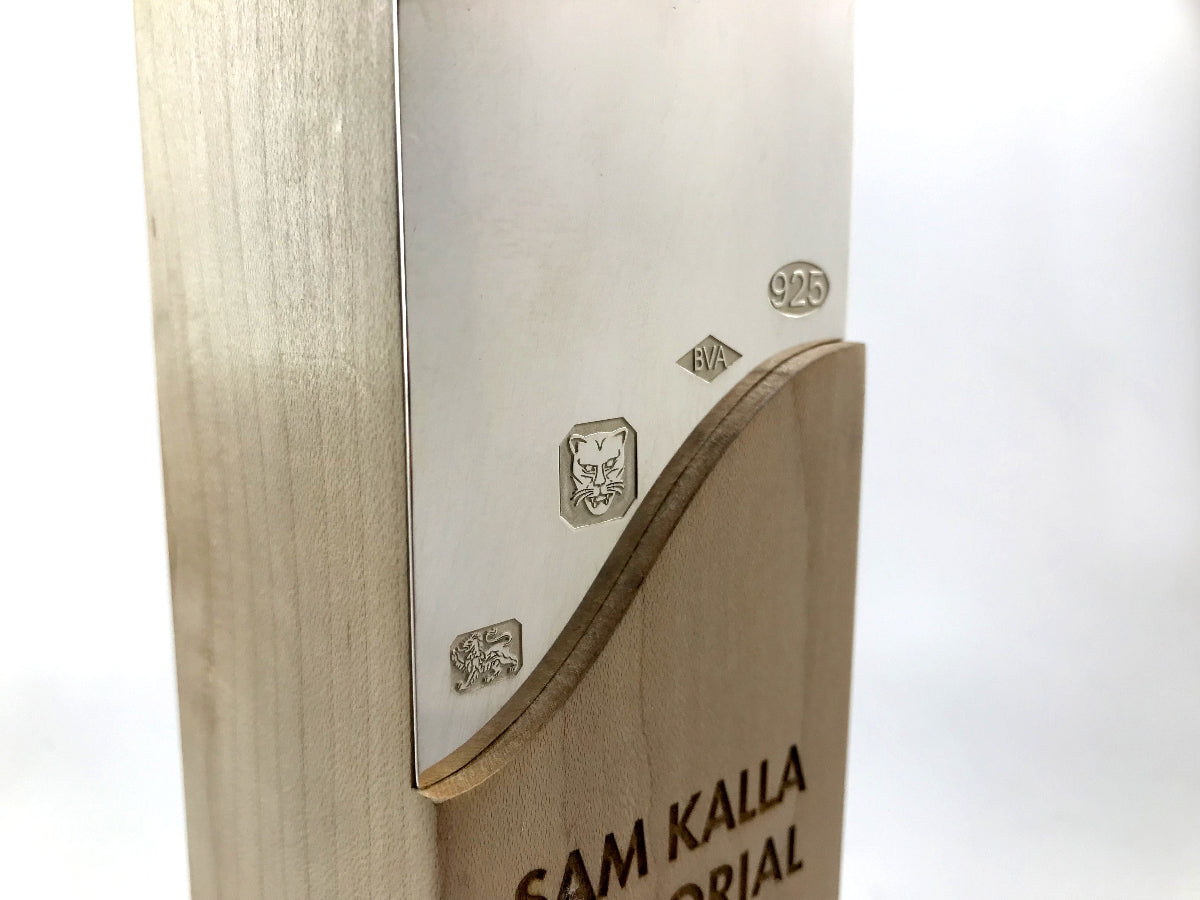 Beautiful engraved sterling silver award inlay on a white background