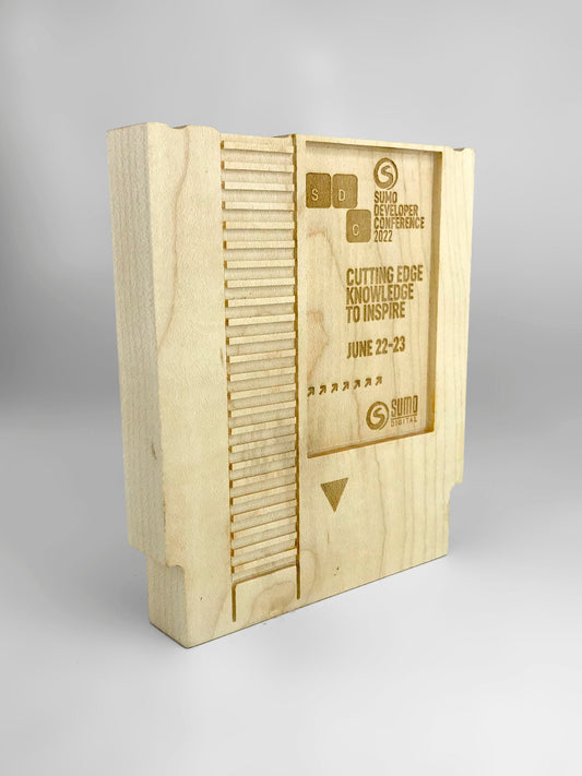 Wooden award with engraved text on a gray background