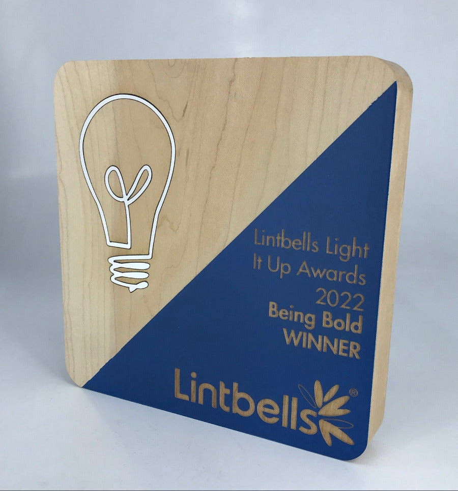 Wooden award with rounded corners, diagonal painted colour and engraved text