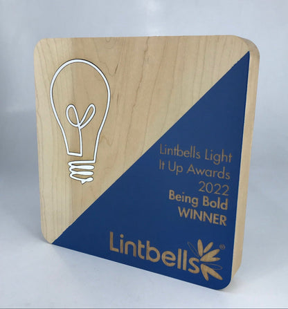 Wooden award with rounded corners, diagonal painted colour and engraved text