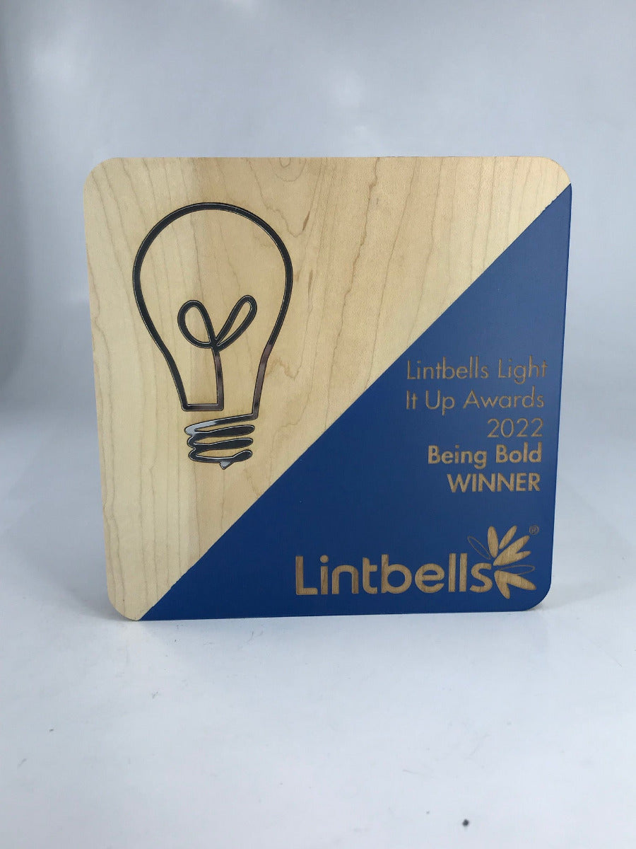 Wooden award with rounded corners, diagonal painted colour and engraved text