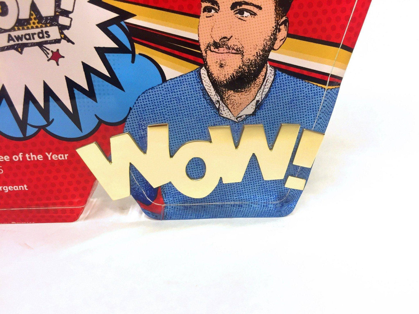 Close up of highly polished gold wow on the WOW award.