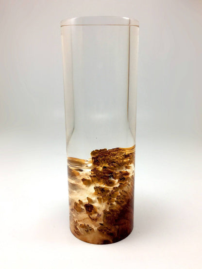 Tall cylindrical award with a textured brown wooden base on a white background