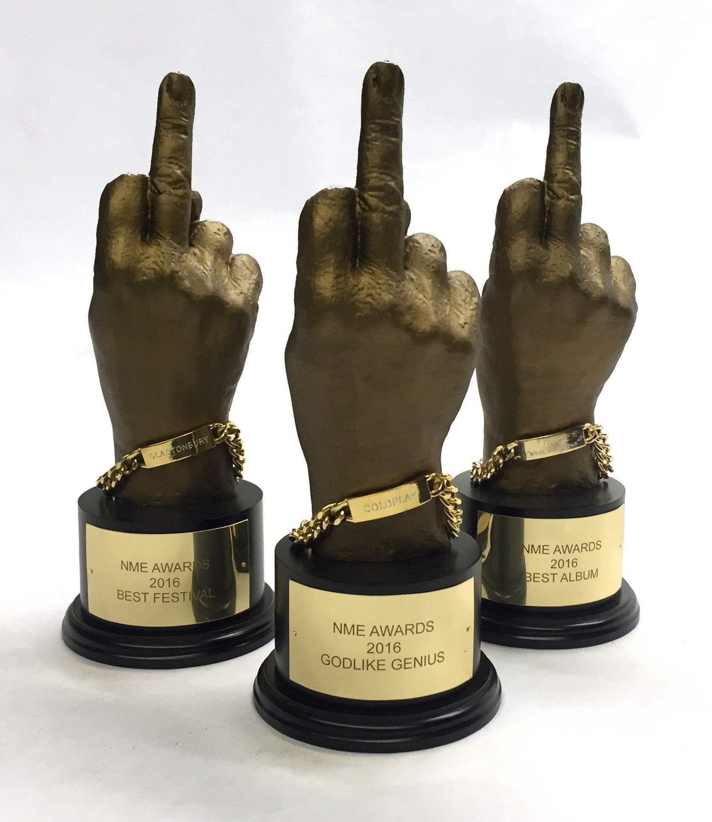trio of gold 3D printed hand awards on a white background