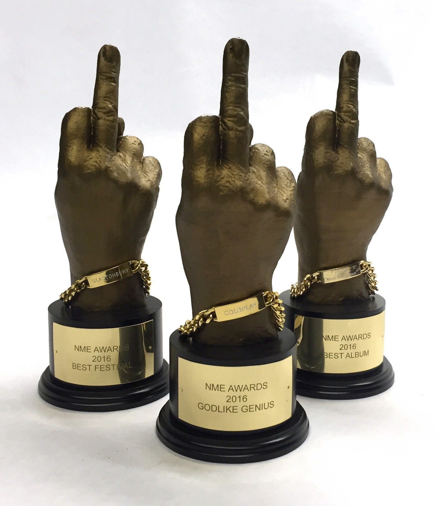 trio of gold 3D printed hand awards on a white background